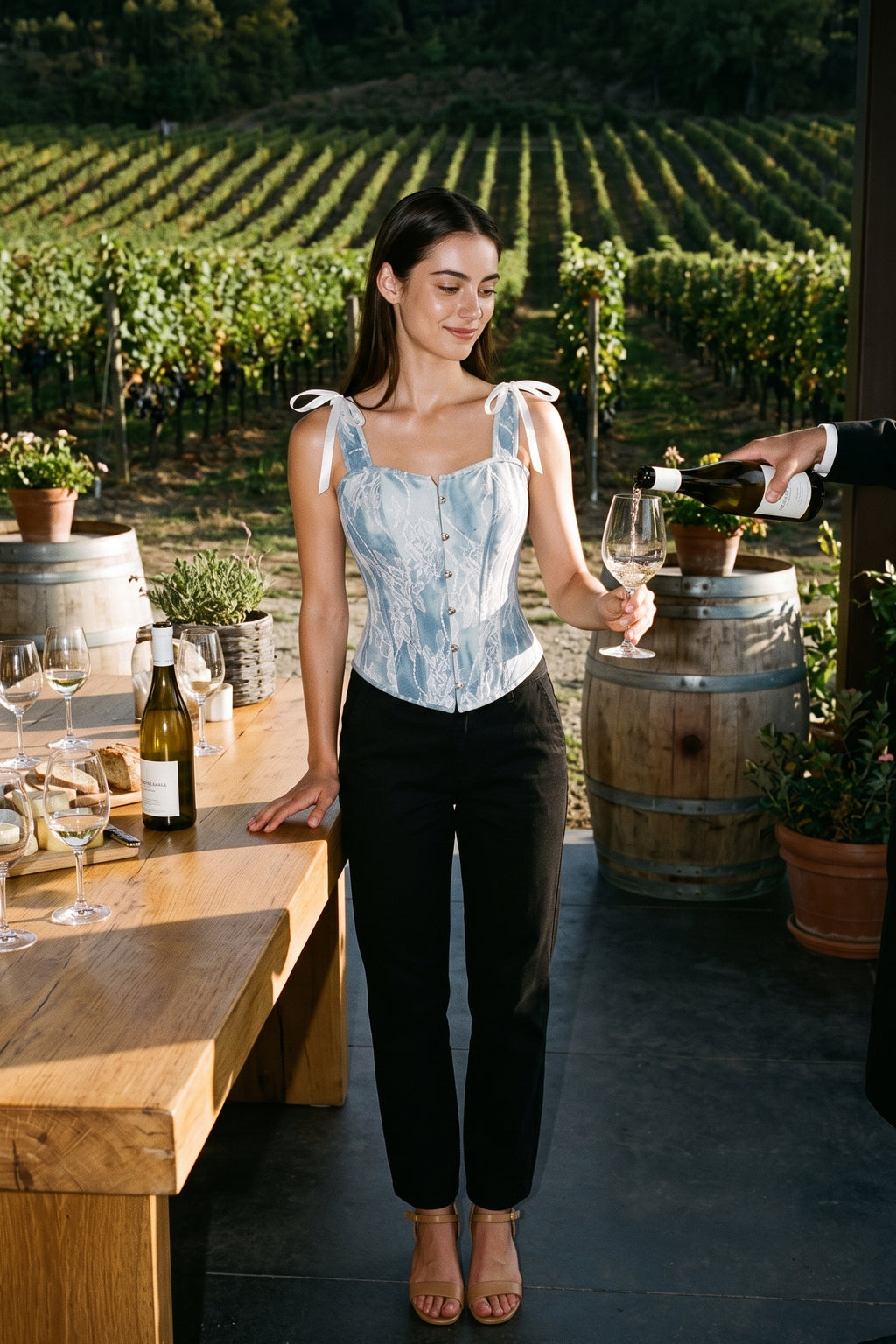 The Denim Lace Corset Top worn with black trousers at an afternoon vineyard tasting