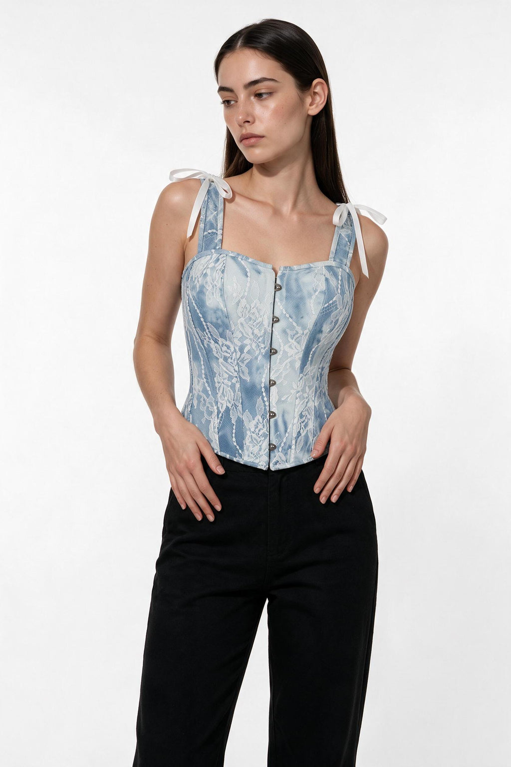 The Denim Lace Corset Top in light denim, three-quarter length view
