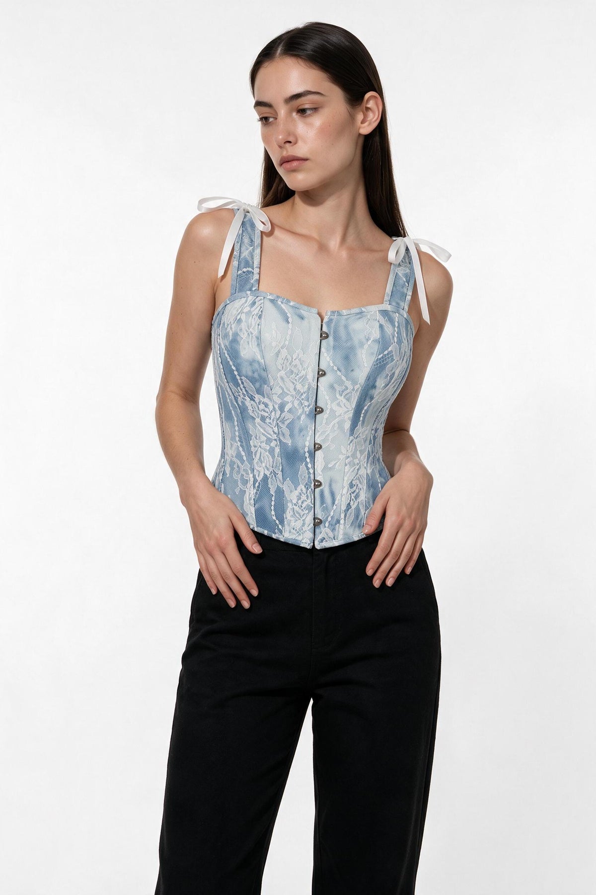 The Denim Lace Corset Top in light denim, three-quarter length view