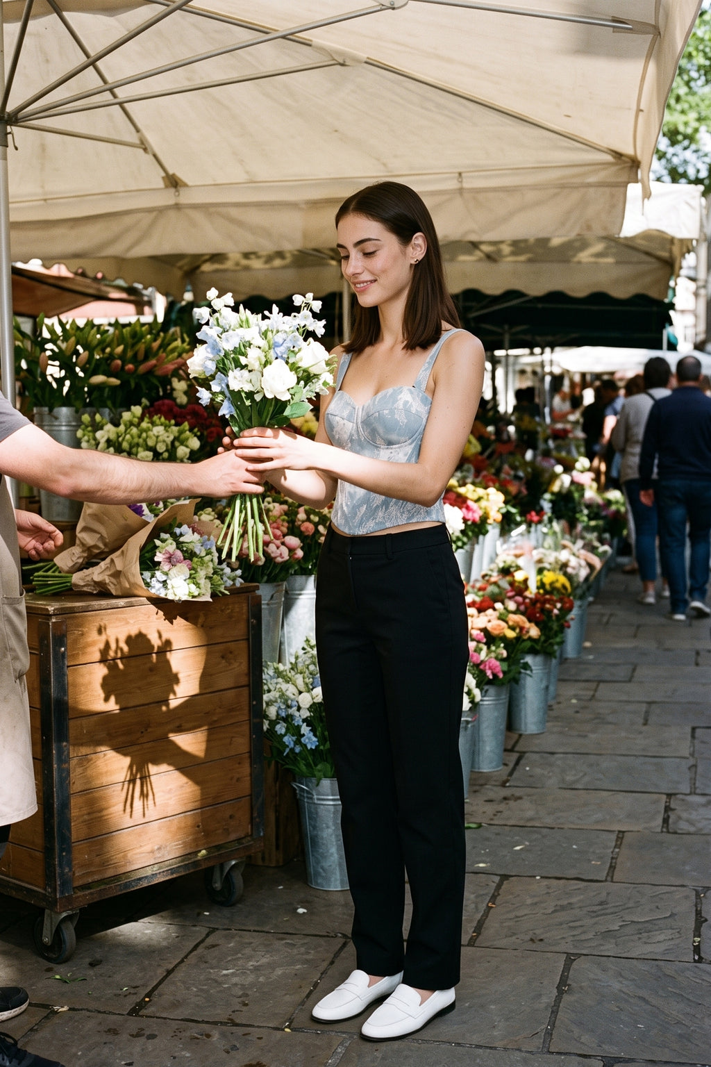 The Denim Lace Bustier worn with black trousers at a morning flower market