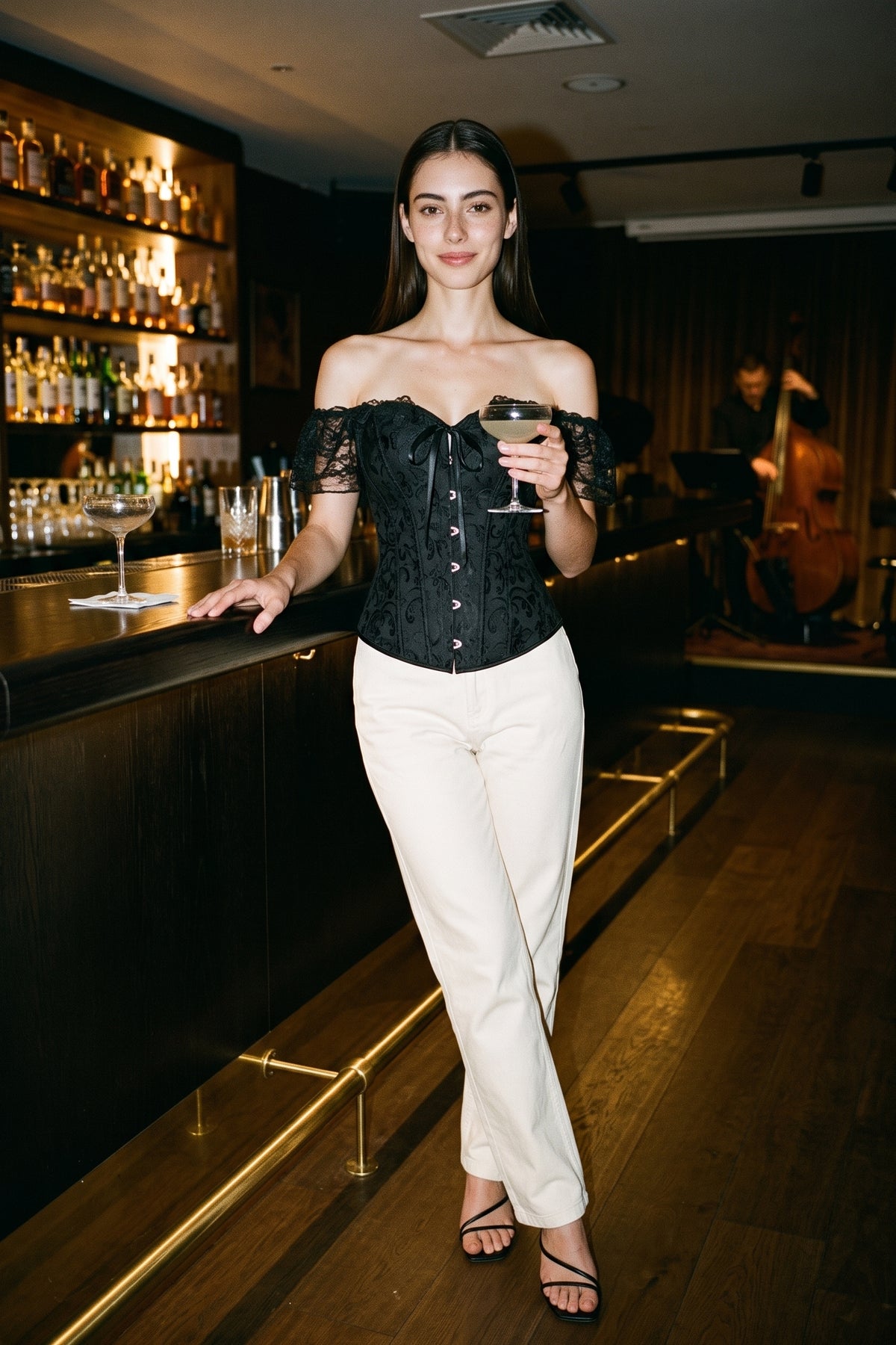 The Off-Shoulder Lace Sleeve Corset Top worn with cream trousers at a jazz bar