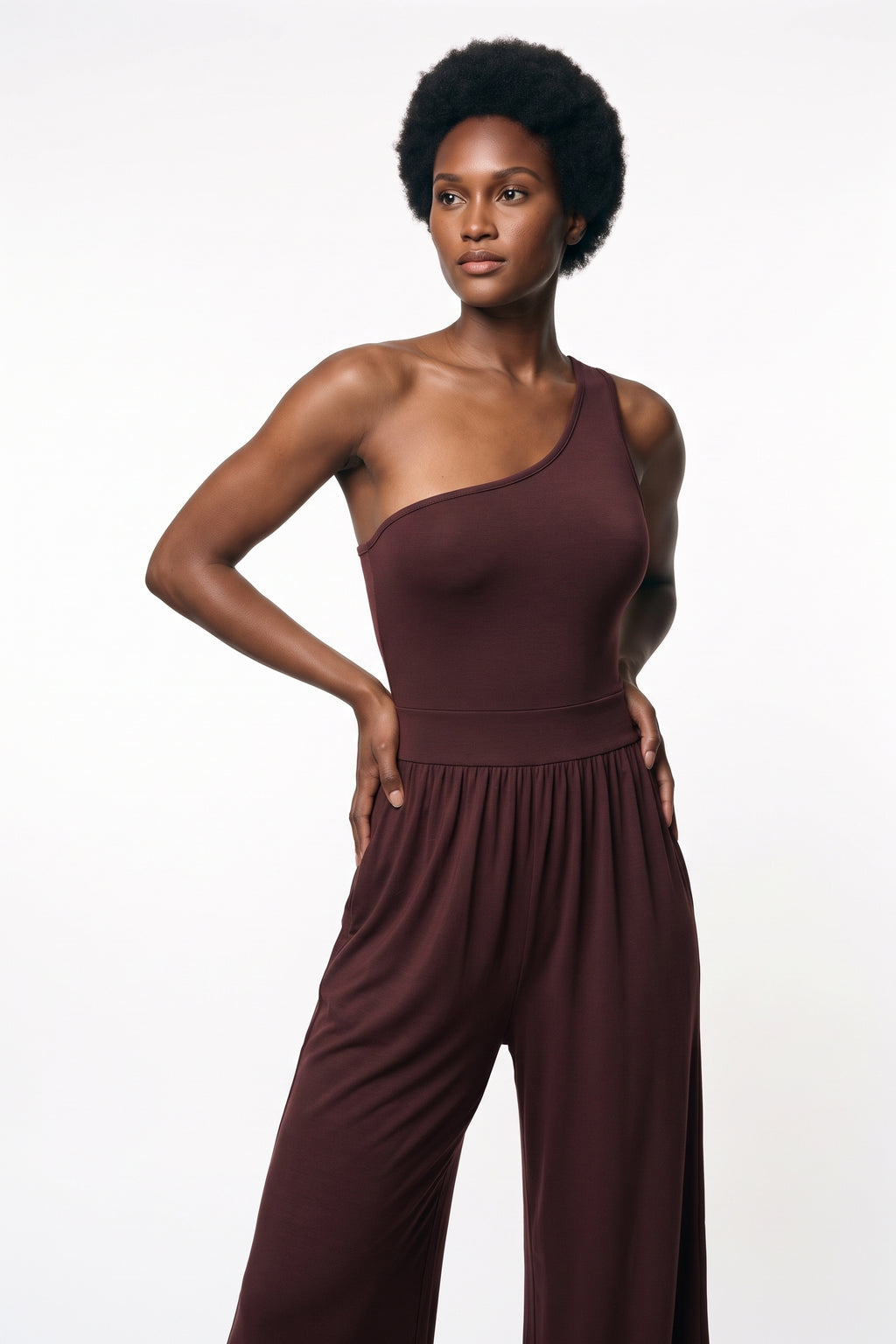 The One-Shoulder Wide-Leg Jumpsuit in burgundy, three-quarter length view
